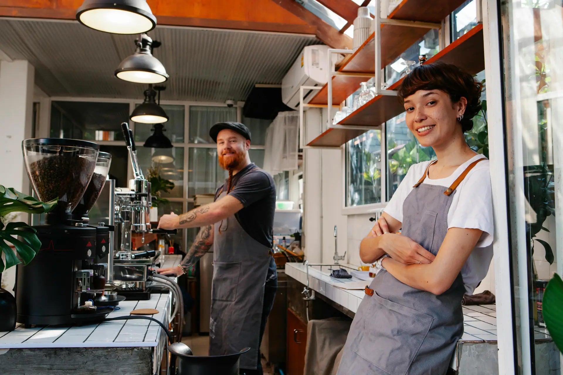Two baristas smiling in a cafe
