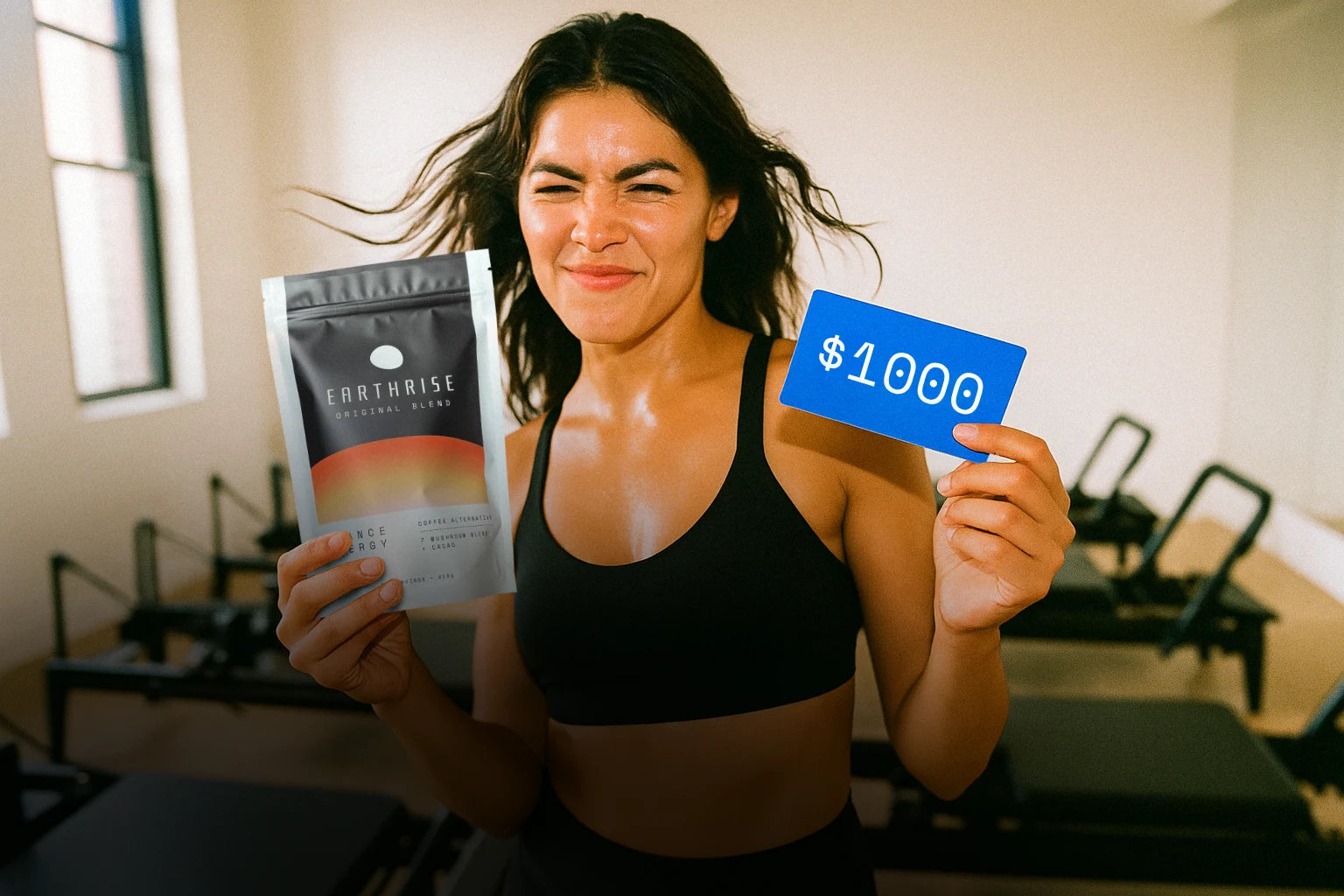 A person holding a bag of Earthrise and a $1000 voucher, sitting in a fitness studio wearing a smile